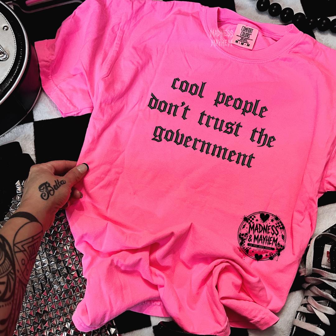 Neon pink cool people don’t trust the government embroidered tshirt